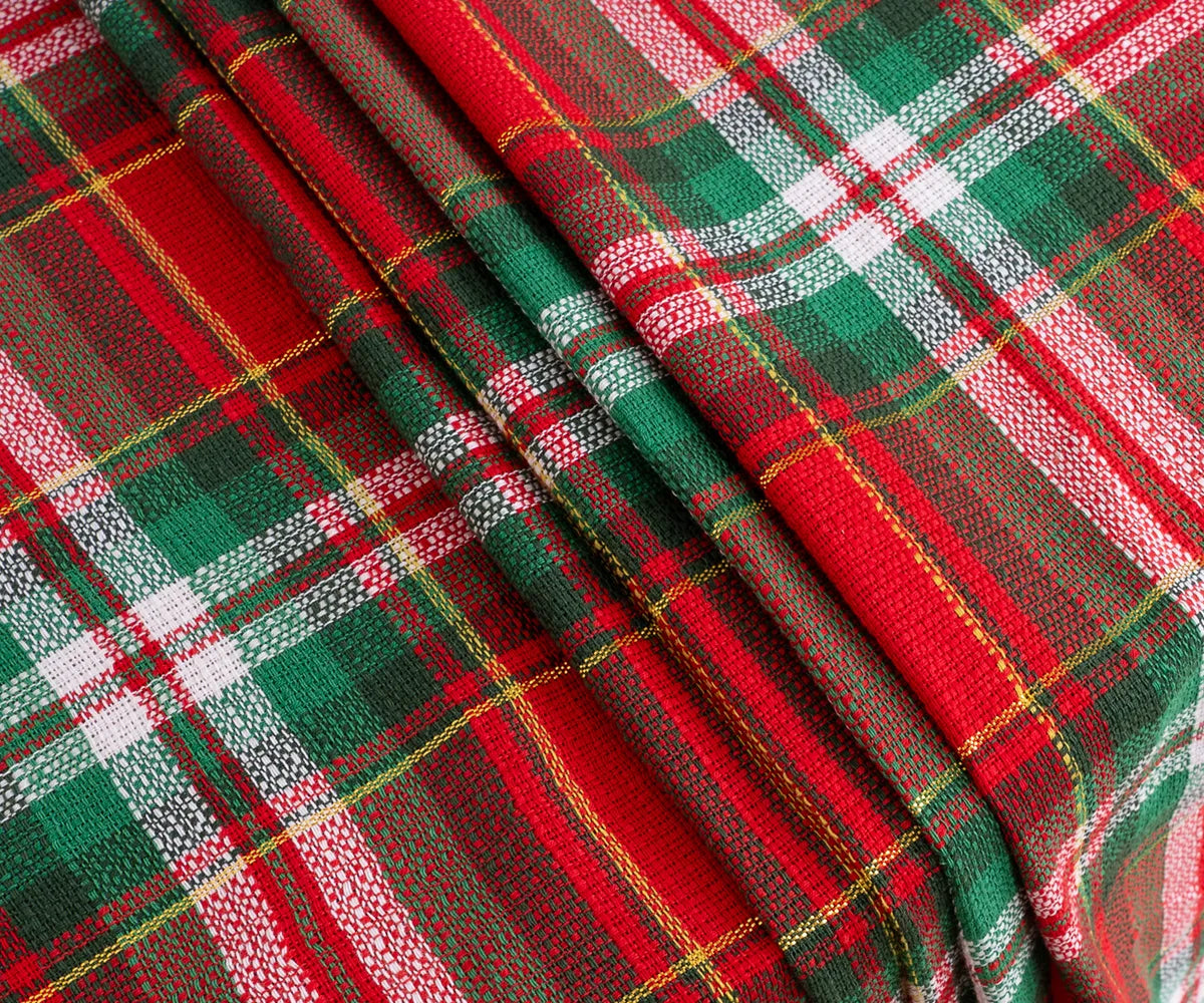 Elegant green tartan cotton tablecloth on dining table, perfect for family dinners or parties
