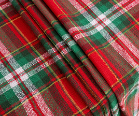 Elegant green tartan cotton tablecloth on dining table, perfect for family dinners or parties