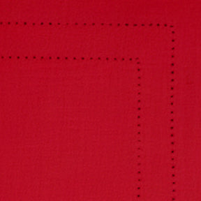 Festive table setup with red cotton hemstitch placemats for holiday dining