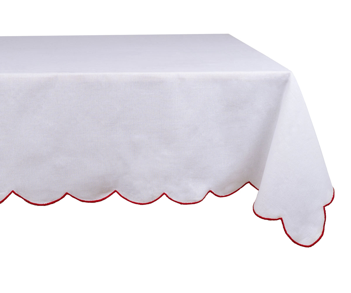 Elegant red cotton tablecloth with embroidered scalloped edges styled on a festive dining table.