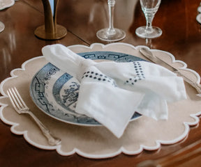 Elegant beige scalloped placemats, washable and perfect for everyday dining.