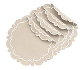 Light beige round scalloped placemat on dining table