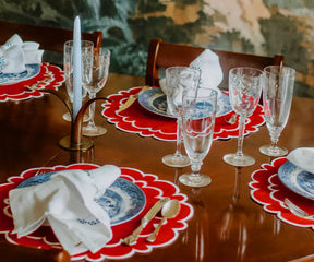 Elegant red scalloped placemats, washable and perfect for festive dining.