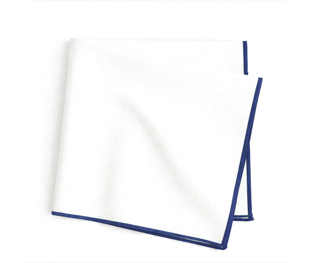 White cotton napkins with royal blue merrow stitch border, bold embroidered napkins for statement table décor