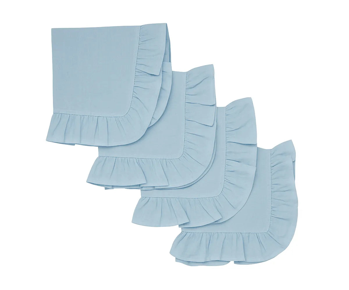 Light blue ruffle cotton cloth napkins set neatly folded on a dining table.