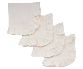 Ruffle edge natural cotton napkins styled on a rustic wooden dining table.