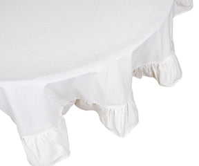 Cozy layered table setting with embroidered napkins and ruffled tablecloth