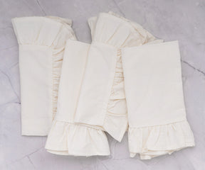 Close-up of delicate ruffle trim on soft cotton napkin for vintage table decor.