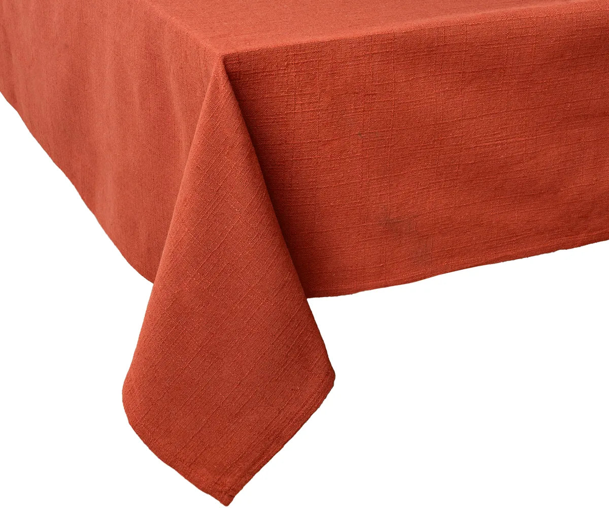 100% cotton rust tablecloth, machine washable and reusable, providing a cozy, elegant touch for indoor and outdoor dining setups.