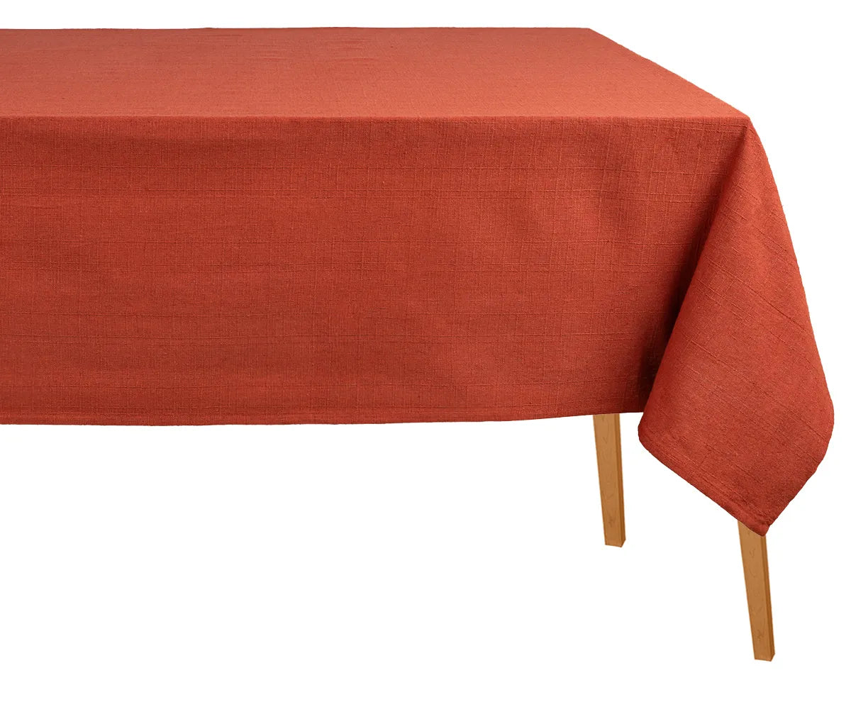 Rust-colored rectangular cotton tablecloth on a dining table, soft and durable fabric, perfect for everyday meals, festive holidays, weddings, or restaurant use.