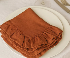 Set of 100% cotton rust-colored ruffled napkins, eco-friendly and washable fabric dinner napkins available in bulk or small sets, perfect for casual meals and elegant celebrations.