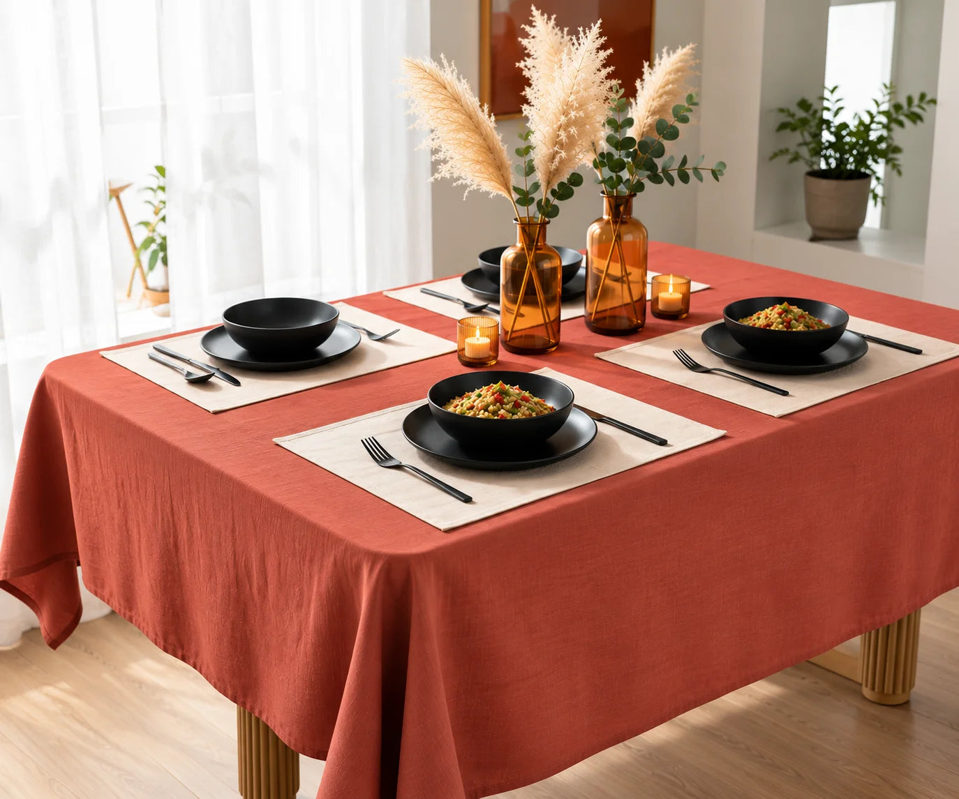 Rust linen tablecloth styled on a rectangular dining table for farmhouse and fall tablescape décor