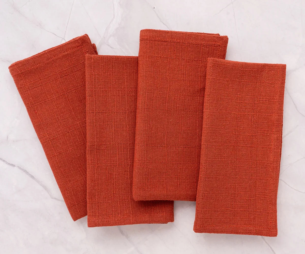 Set of 12 rust cloth napkins in 100% cotton, machine washable, soft, and durable for family dinners and restaurant use
