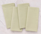Wedding reception table decorated with sage green cotton napkins, offering a sustainable, elegant, and eco-friendly table linen option