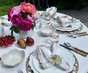 Close-up of beige scallop napkins folded elegantly, perfect for a refined dining experience.