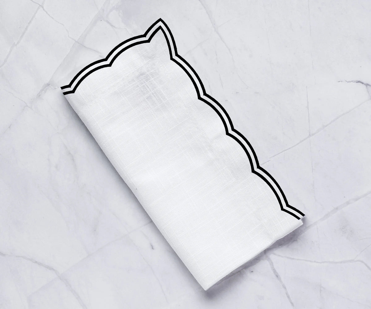 Set of black cotton napkins with scalloped trim for wedding or event décor