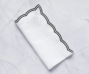Set of black cotton napkins with scalloped trim for wedding or event décor