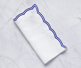 Elegant royal blue dinner napkins with a soft scalloped edge design