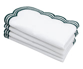 Luxury green scalloped embroidered napkins on a marble surface, perfect for fine dining.