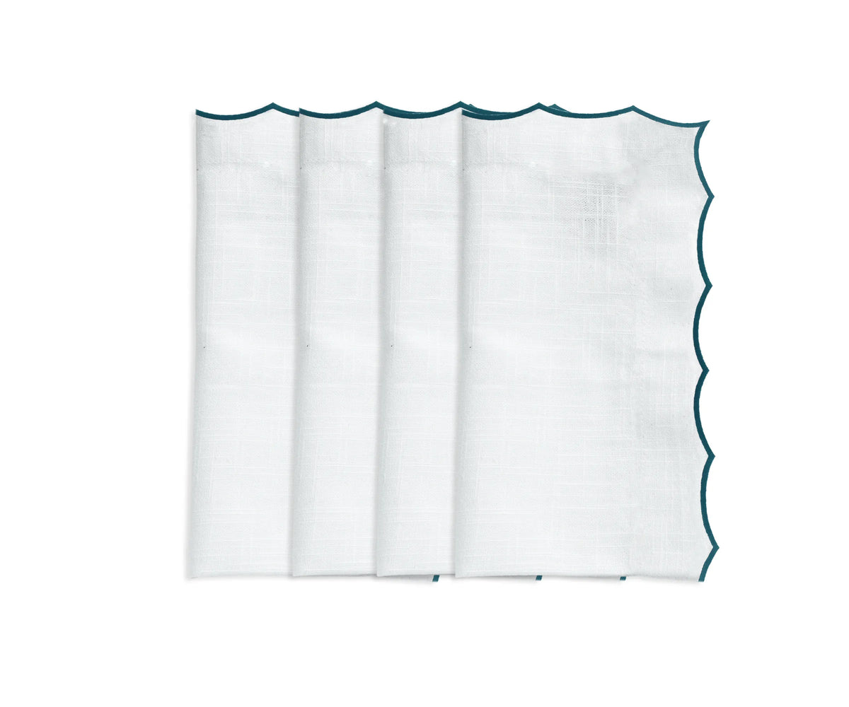 Elegant embroidered cotton napkins with scalloped edges for wedding and event table décor.