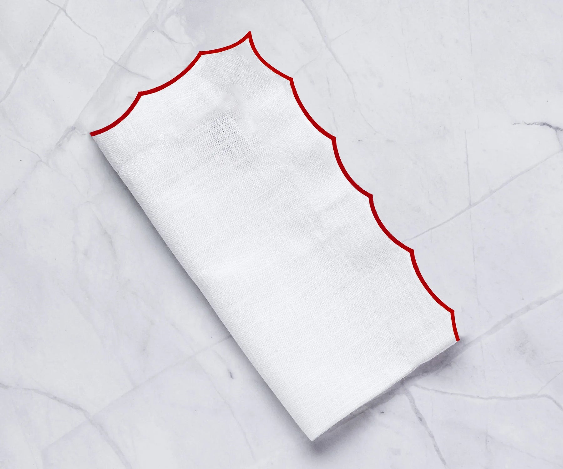 Classic cotton napkins with detailed scalloped edging for timeless table presentations.