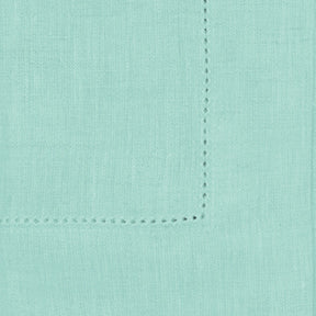 Seafoam green linen napkins styled on a modern dining table, adding a fresh and refined look to the table setting.

