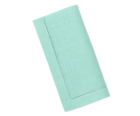 Elegant hemstitched linen napkin in seafoam green, neatly folded to highlight detailed stitching and smooth linen fabric.