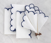 Scallop napkins - cloth napkins with scalloped edges, accented by embroidered details.