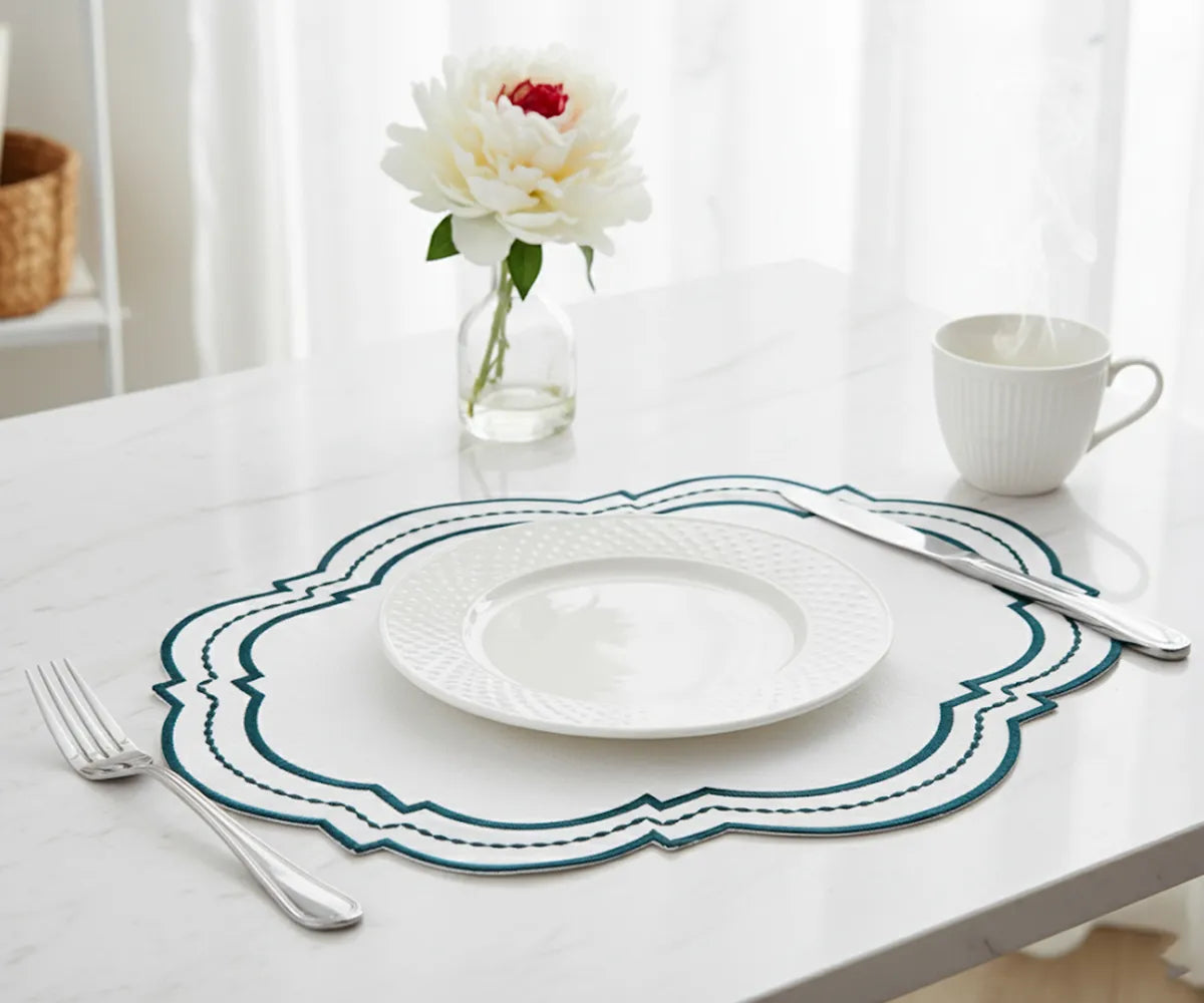 Farmhouse-style green cotton placemats with intricate white edges
