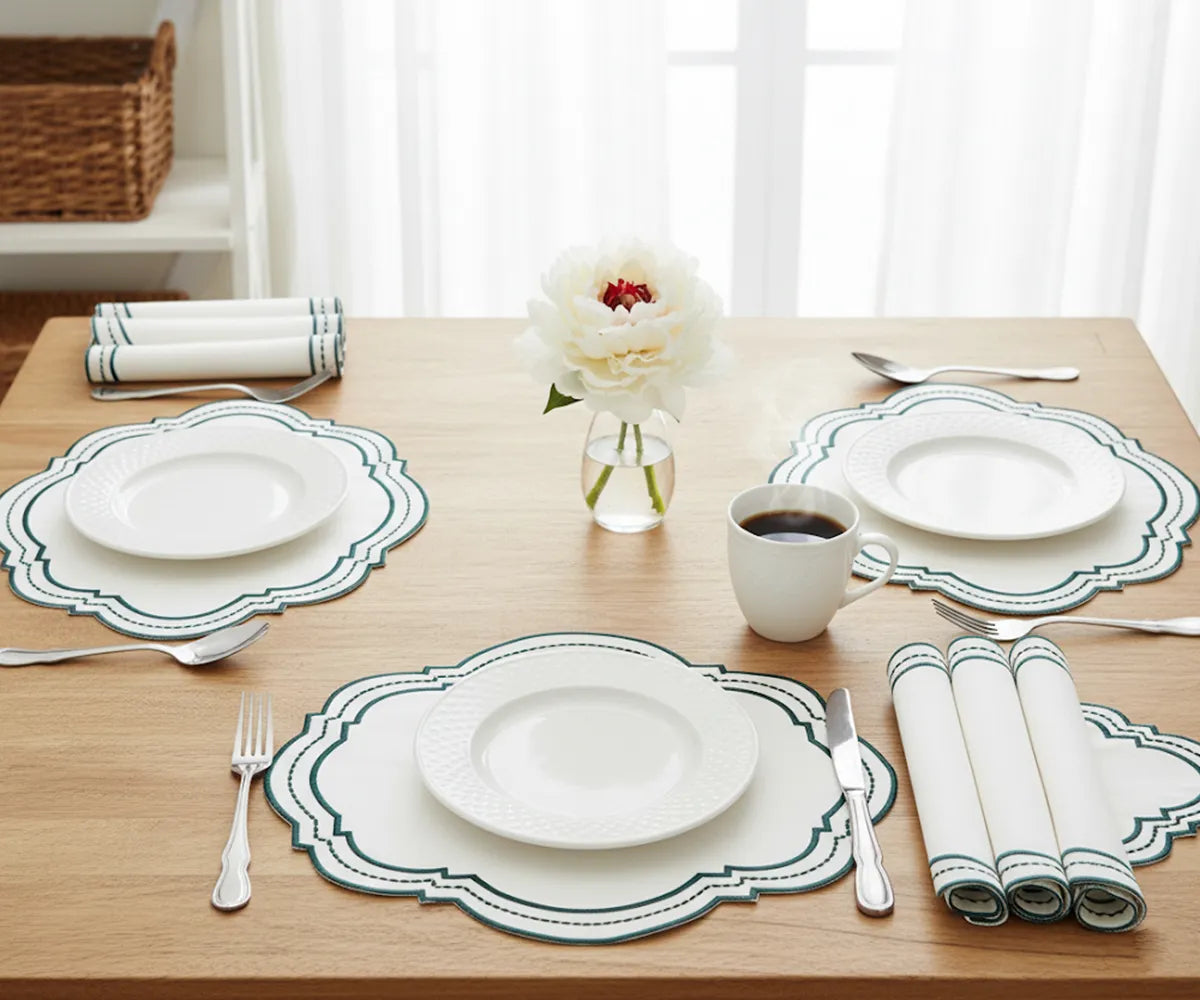Oval green cotton placemats with white detailing, perfect for bright tablescapes