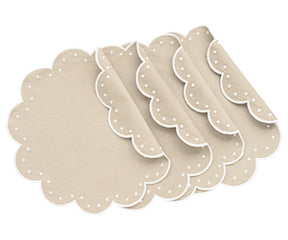 Light beige round scalloped cotton placemats on dining table