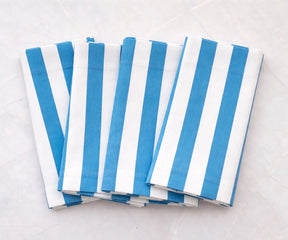 Elegant striped dinner napkins folded for a refined table setting with a relaxed feel