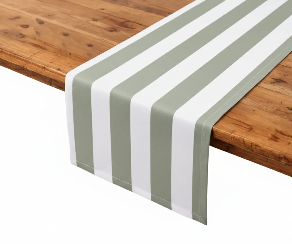 Sage and white cabana stripe table runner made from breathable cotton linen fabric, perfect for spring table decor and rustic wedding styling. This striped dining table runner brings a fresh, natural look to farmhouse interiors and seasonal gatherings. Reusable, easy-care table linen designed for everyday dining and special occasions.