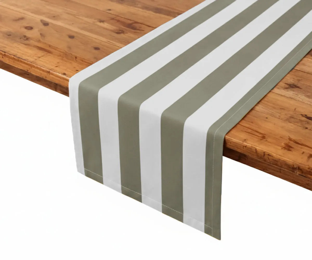 Olive and white cabana stripe table runner crafted from high-quality cotton and linen, offering an earthy, organic feel for farmhouse table decor and holiday table settings. This striped cotton linen table runner enhances dining table styling with a clean, tailored finish. Durable, washable, and ideal for everyday and event use.