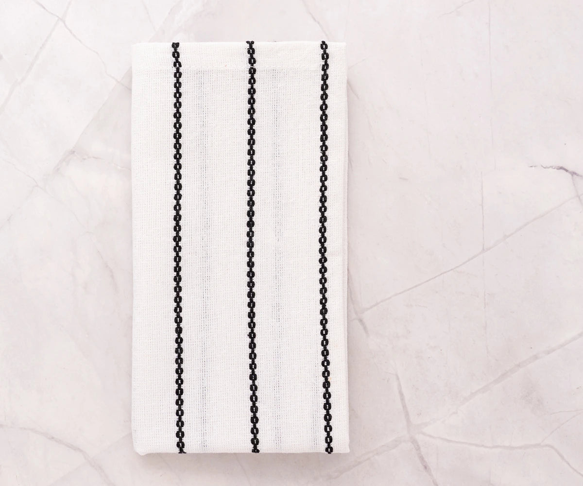 embroidered on black and white napkin