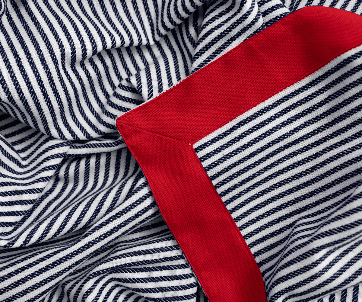 Patterned striped tablecloths with a navy base and red color stripes, enhancing your dining room decor.