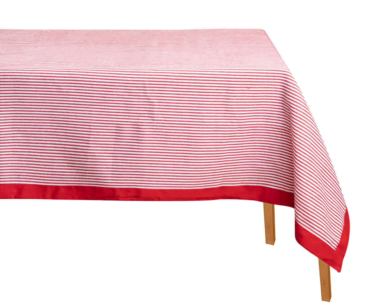 Red and white striped tablecloth on a wooden table with a white background