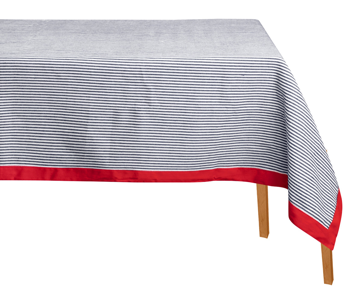 Tablecloth with blue and white stripes and red border on a white background