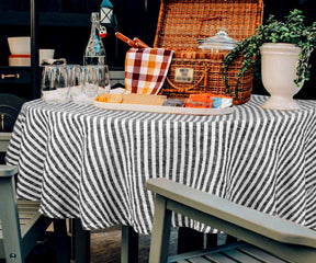 A blue and white striped table cover is a simple and functional table cloth for round tables.