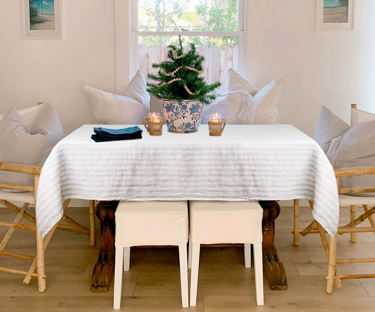 A luxurious beige linen tablecloth draping elegantly over a dining table.