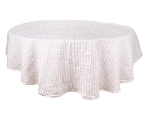A round linen tablecloth in a calming beigehue.