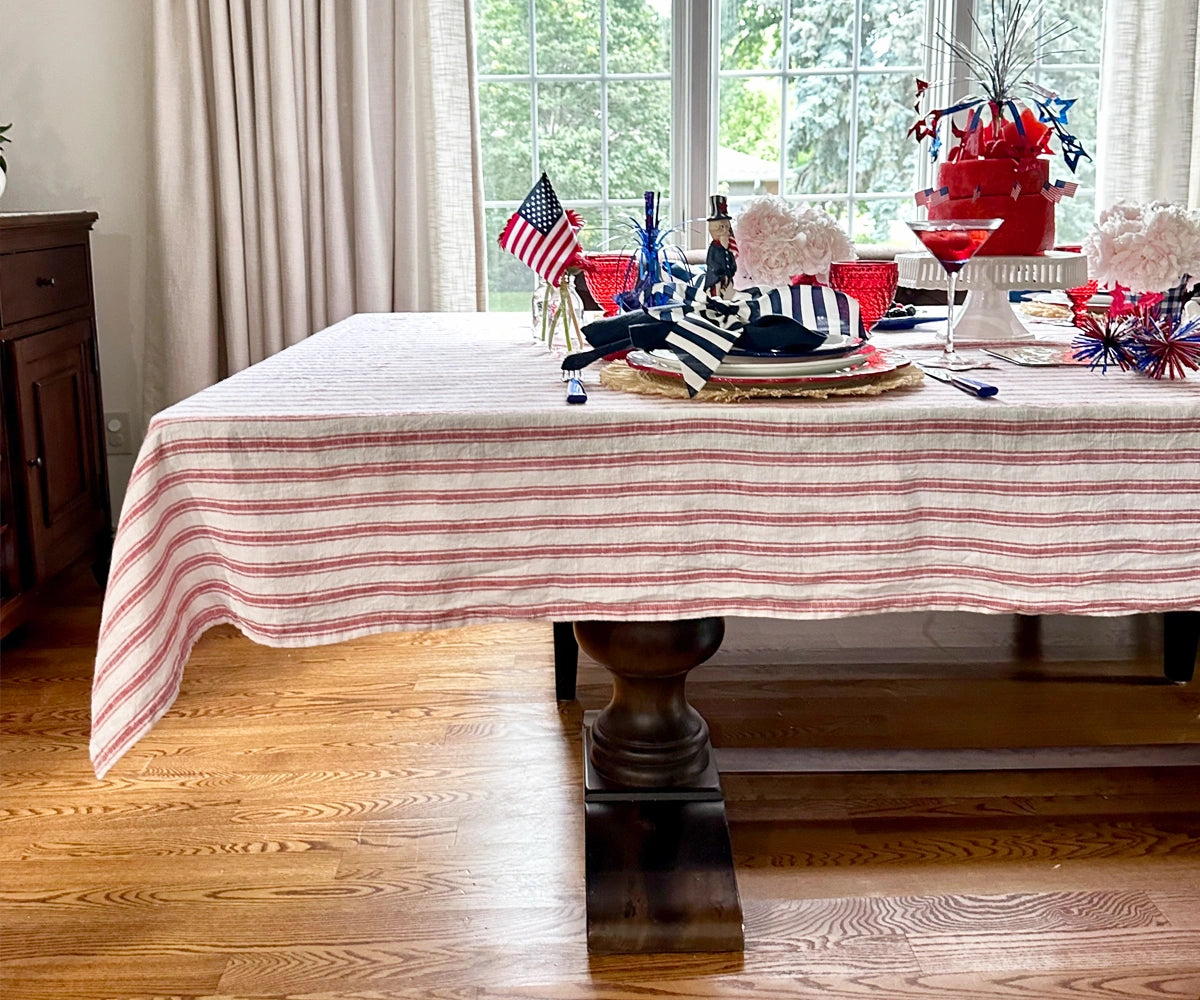 Dining table set with a rectangle tablecloth, styled with plates and cutlery for a modern look