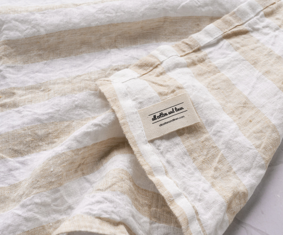 Close-up detail of an Italian Stripe Napkin with beige and white stripes