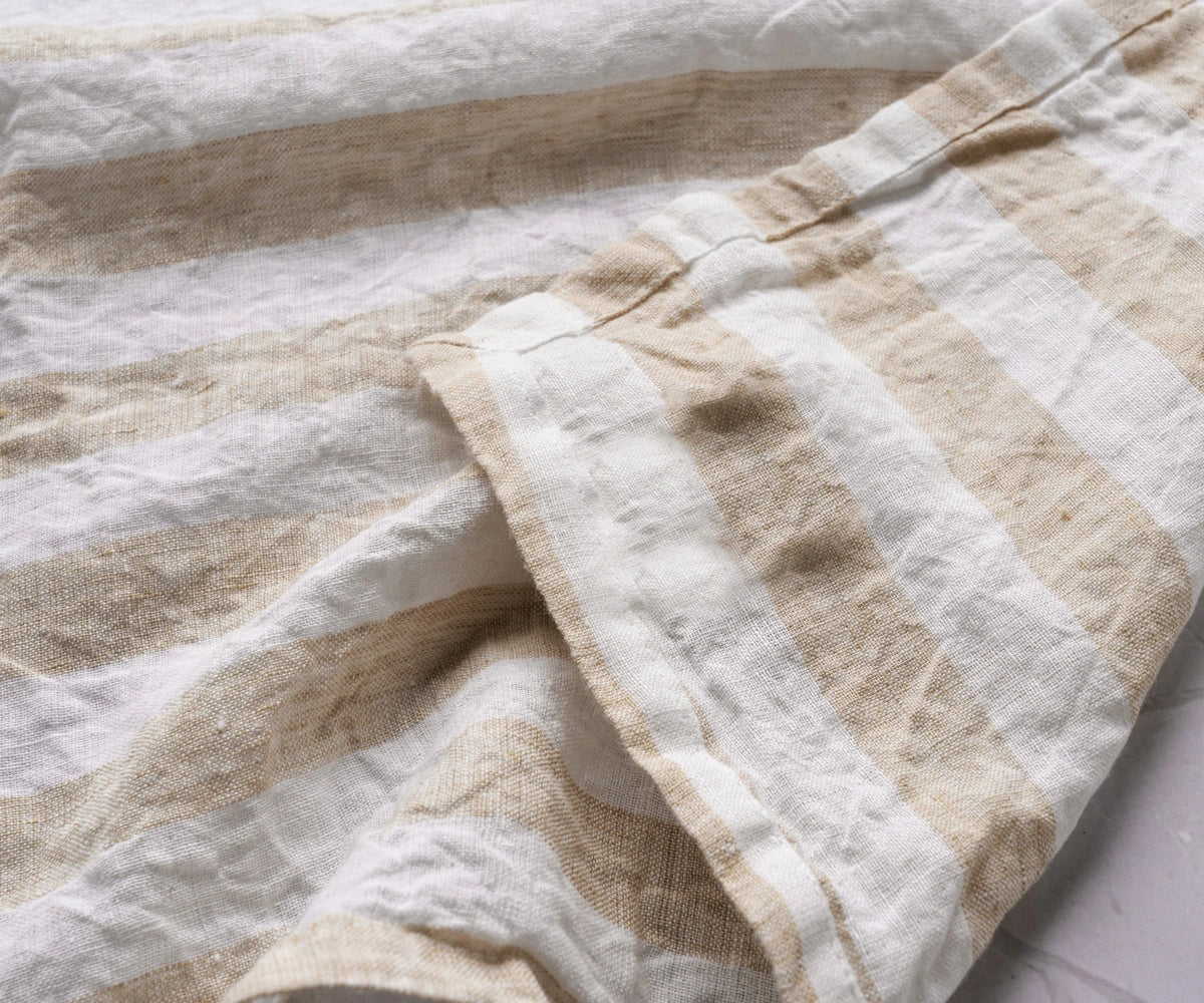 Close-up of beige and white striped fabric on a light background
