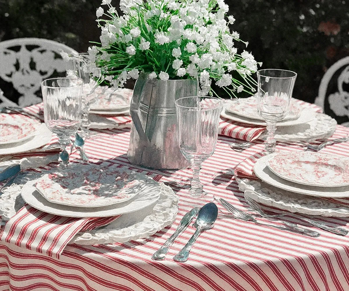 Red and white striped cotton tablecloth on a dining table for farmhouse decor