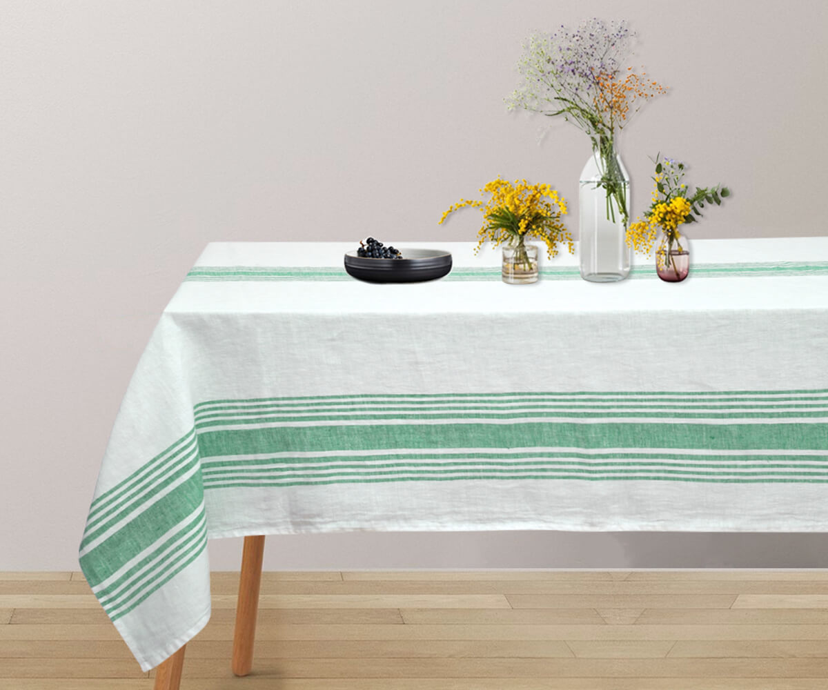 spring tablecloth on a table with a vase of fresh flowers as a centerpiece.