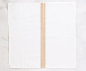 Farmhouse-style napkins, featuring simple patterns, contribute to a relaxed and inviting atmosphere.