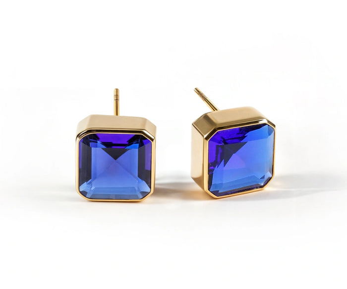 Blue sapphire stud earrings for women featuring a 10mm Asscher-cut gemstone in 18K yellow gold plated brass with secure push-back closure.