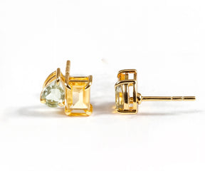 Duo Green Amethyst Toi et Moi stud earrings featuring emerald-cut and pear-cut stones set in 18K yellow gold-plated brass with a secure push-back closure.