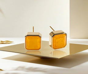 Close-up of gold stud earrings for women featuring vibrant yellow quartz stone.